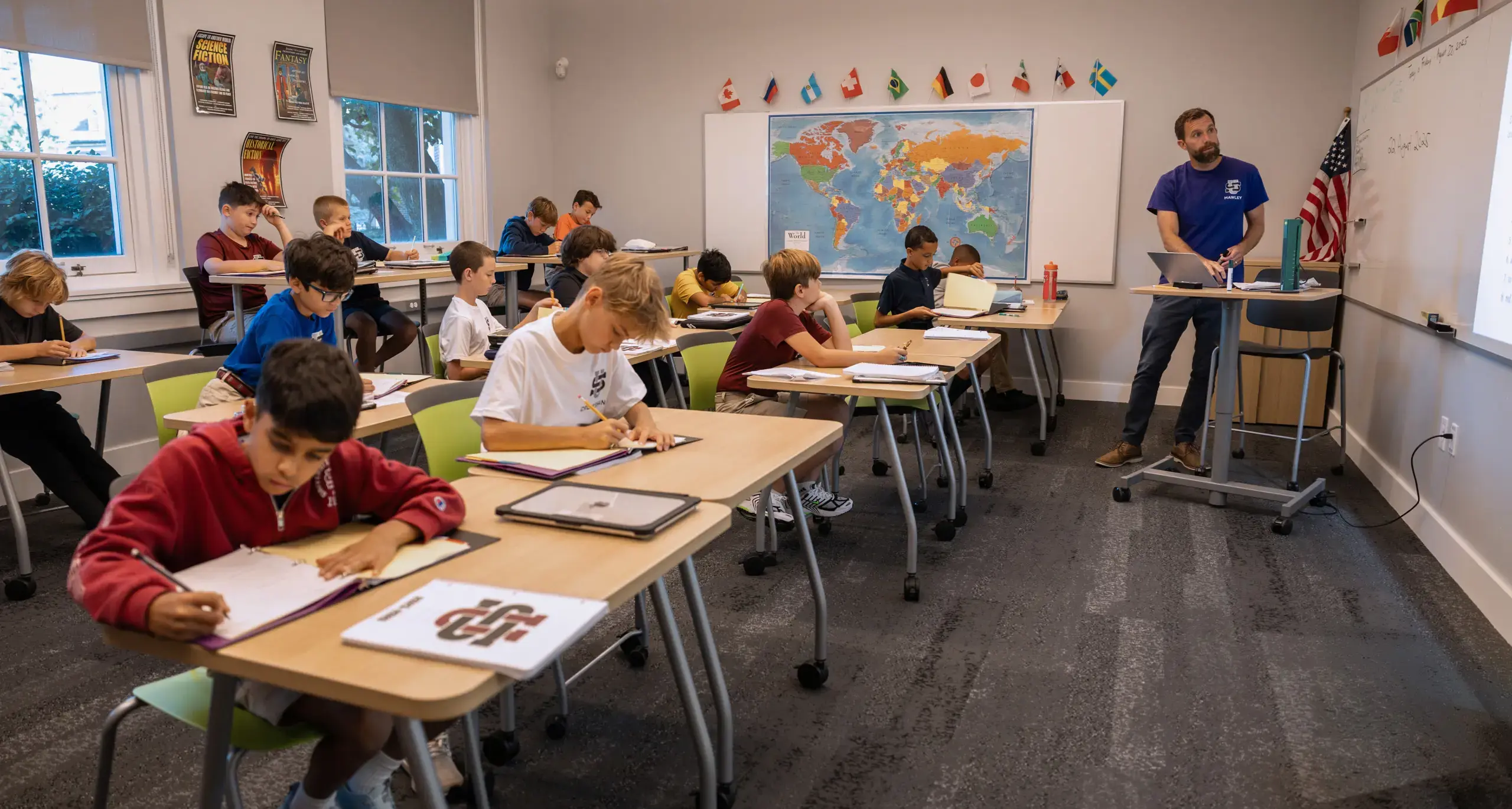 Students listening and taking notes while teacher goes through lesson in class