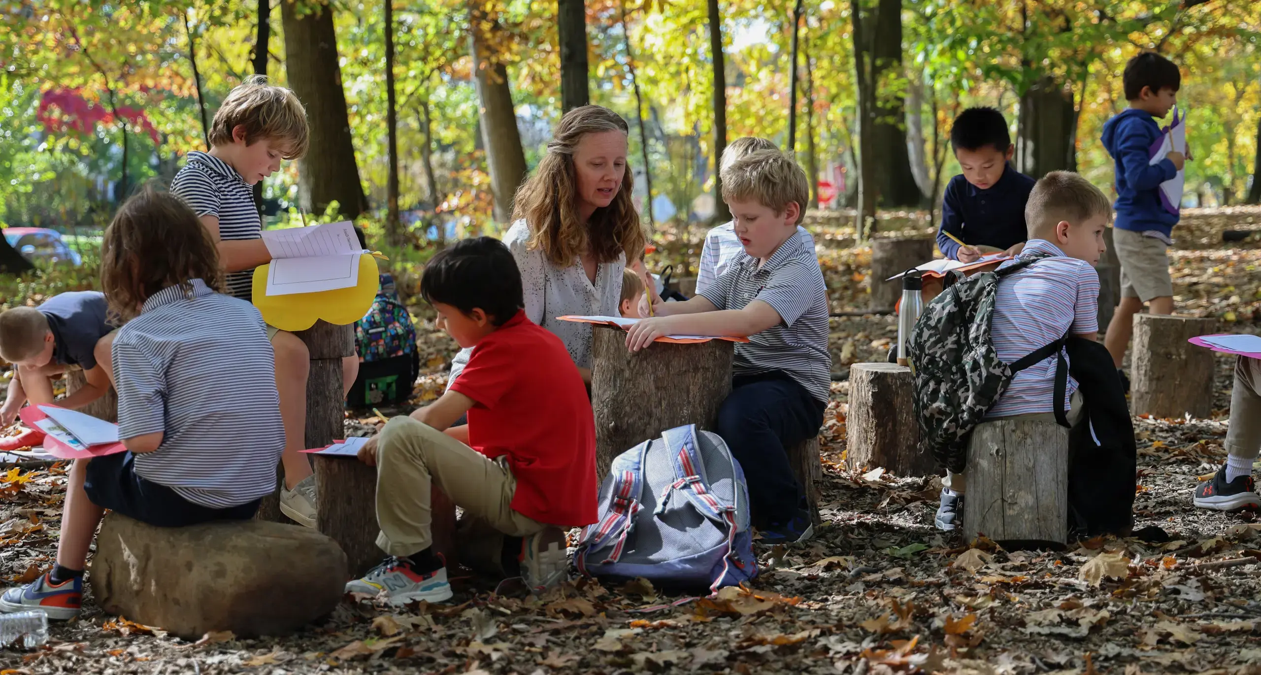 Students and teacher ourdoors doing activities