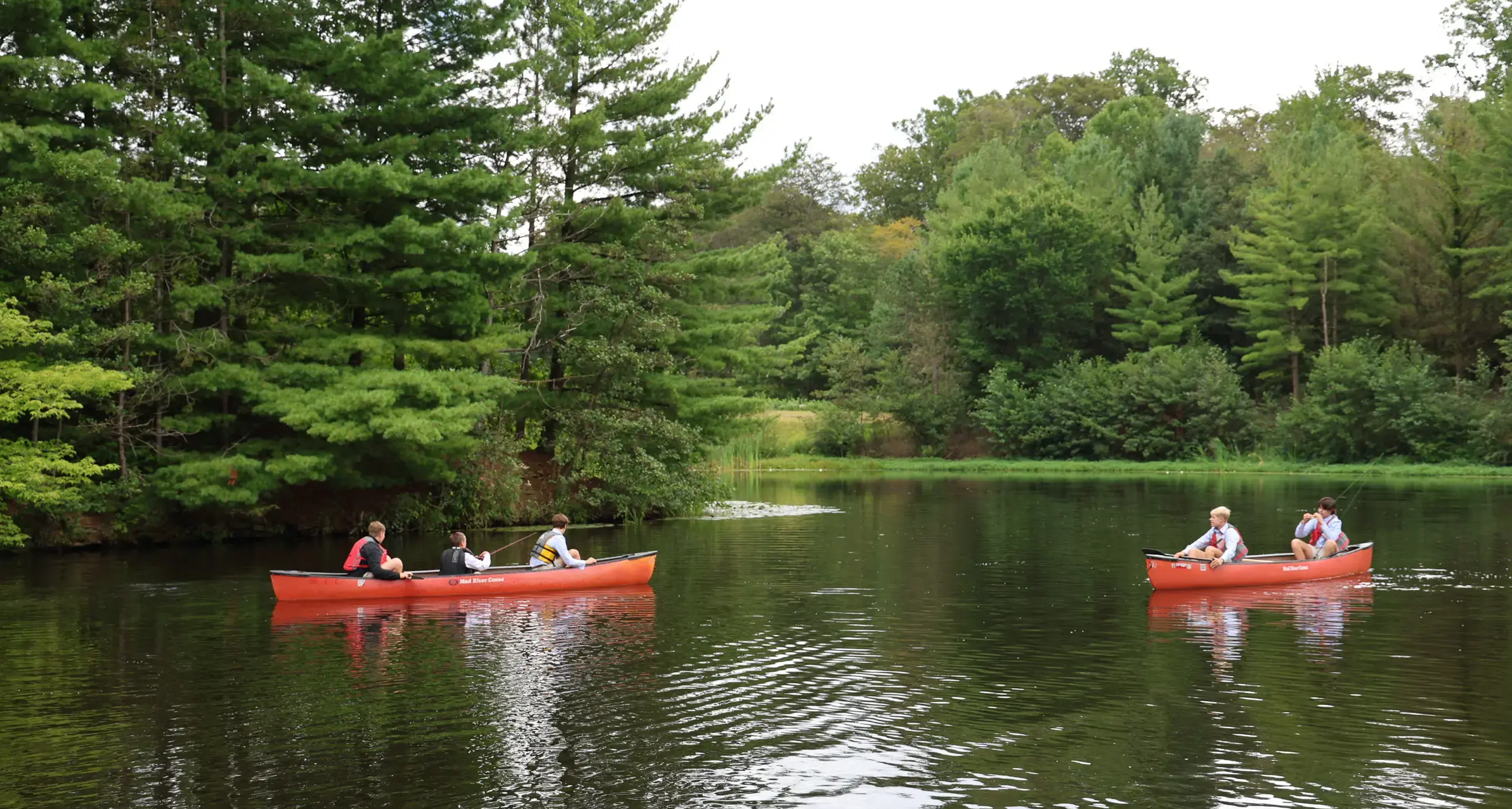 Students Canoeing on lake