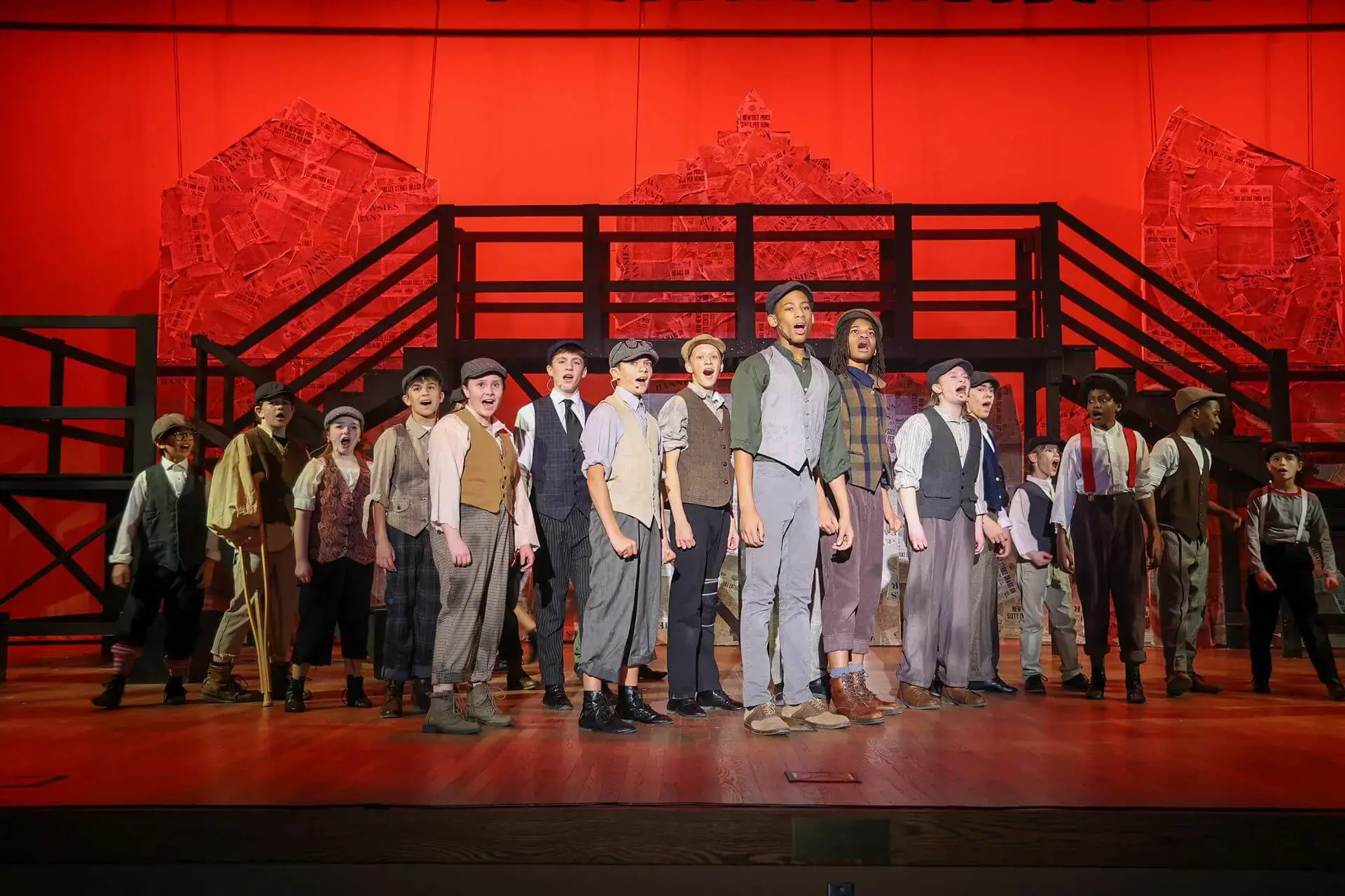 Student cast singing together on stage during the Middle School Theatre production.