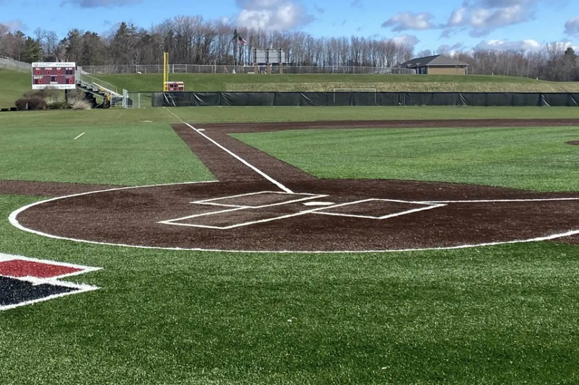 View of the baseball diamond at University School from behind the batter's box on a bright, sunny day.