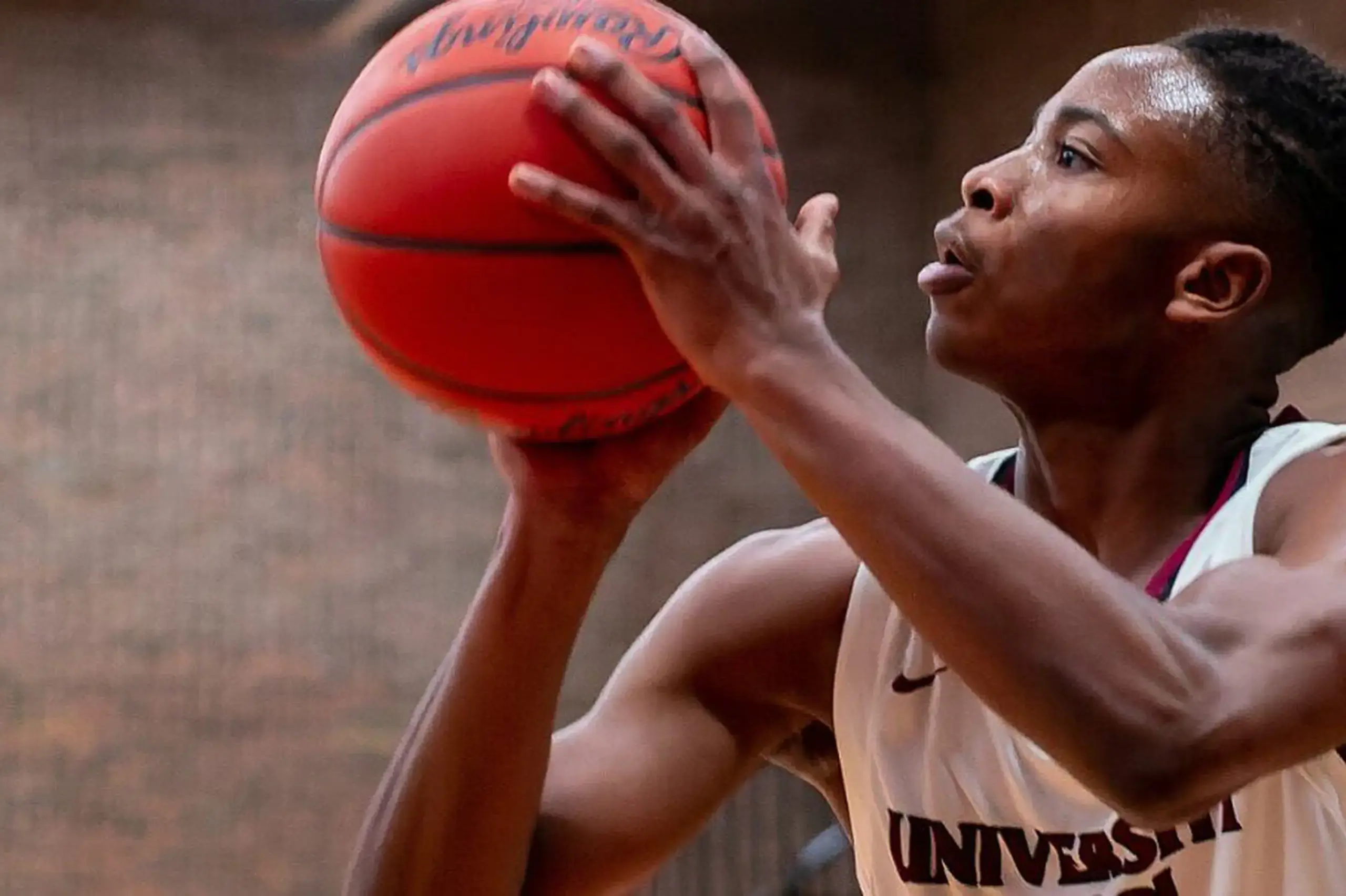 University School student playing basketball.