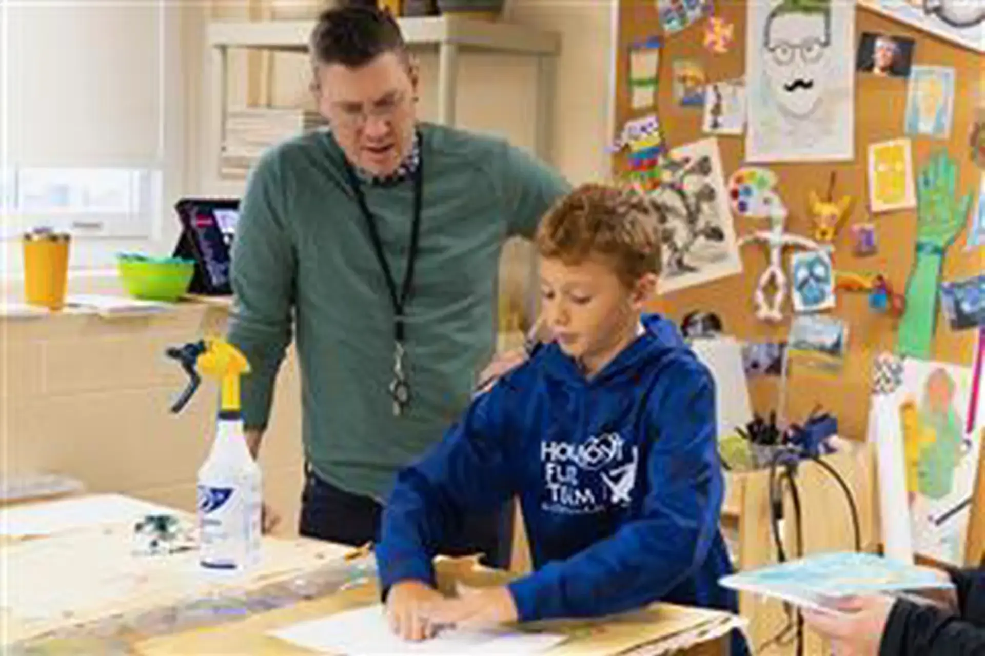 David Barresi overseeing students printmaking in an Art class.