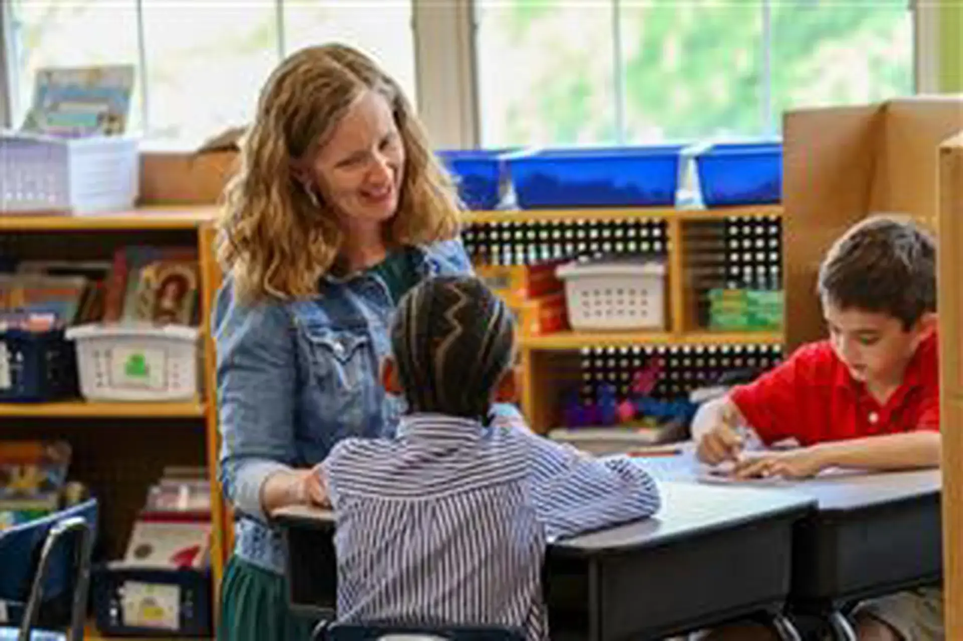 Brittney Schaner helping Grade 1 students with their classwork.