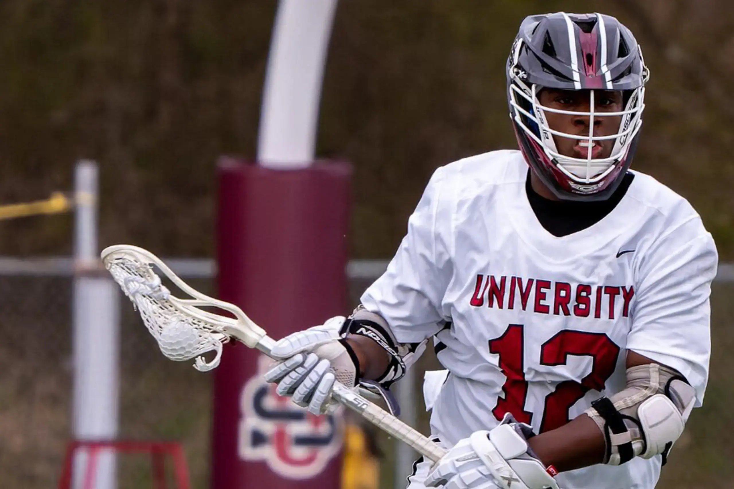 University School student playing in a Lacrosse game.