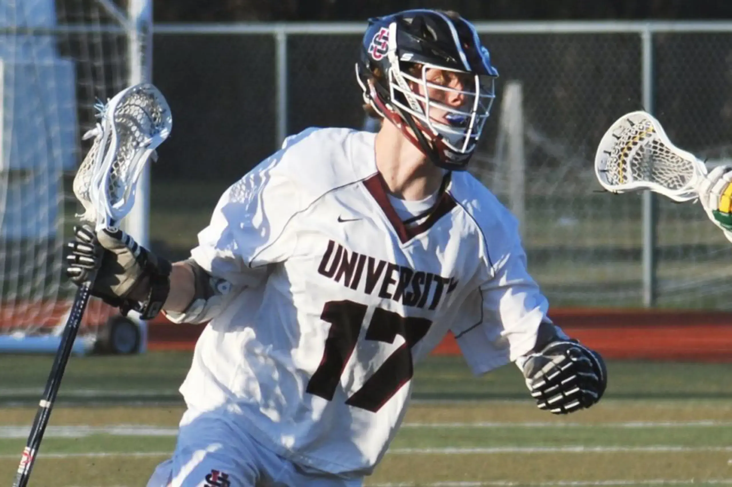 University School lacrosse player running across the pitch during a game.