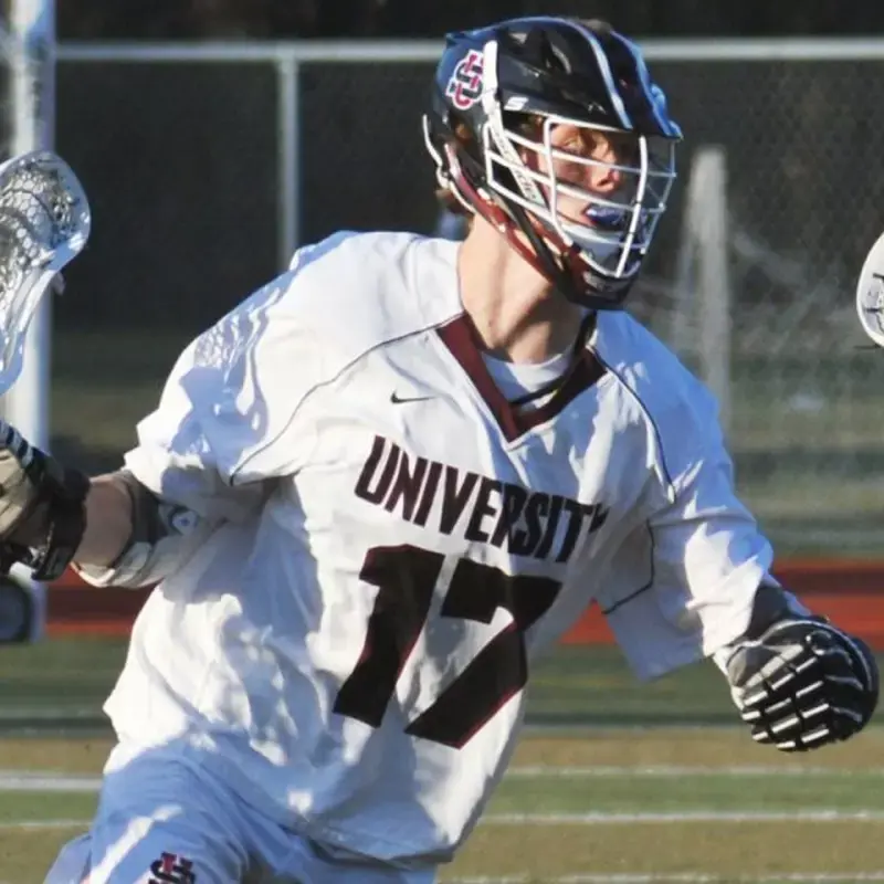 University School lacrosse player running across the pitch during a game.