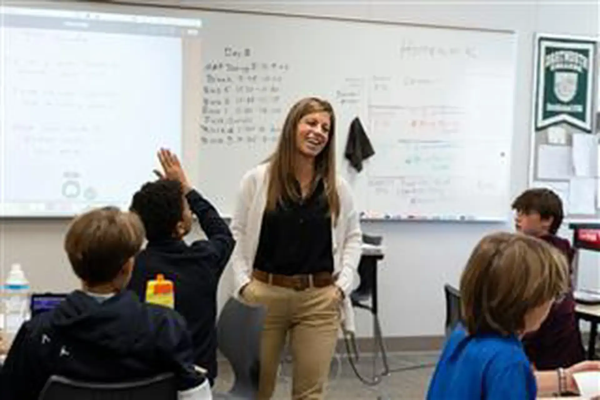 Veronica Zawie teaching an English class, a student raises their hand.