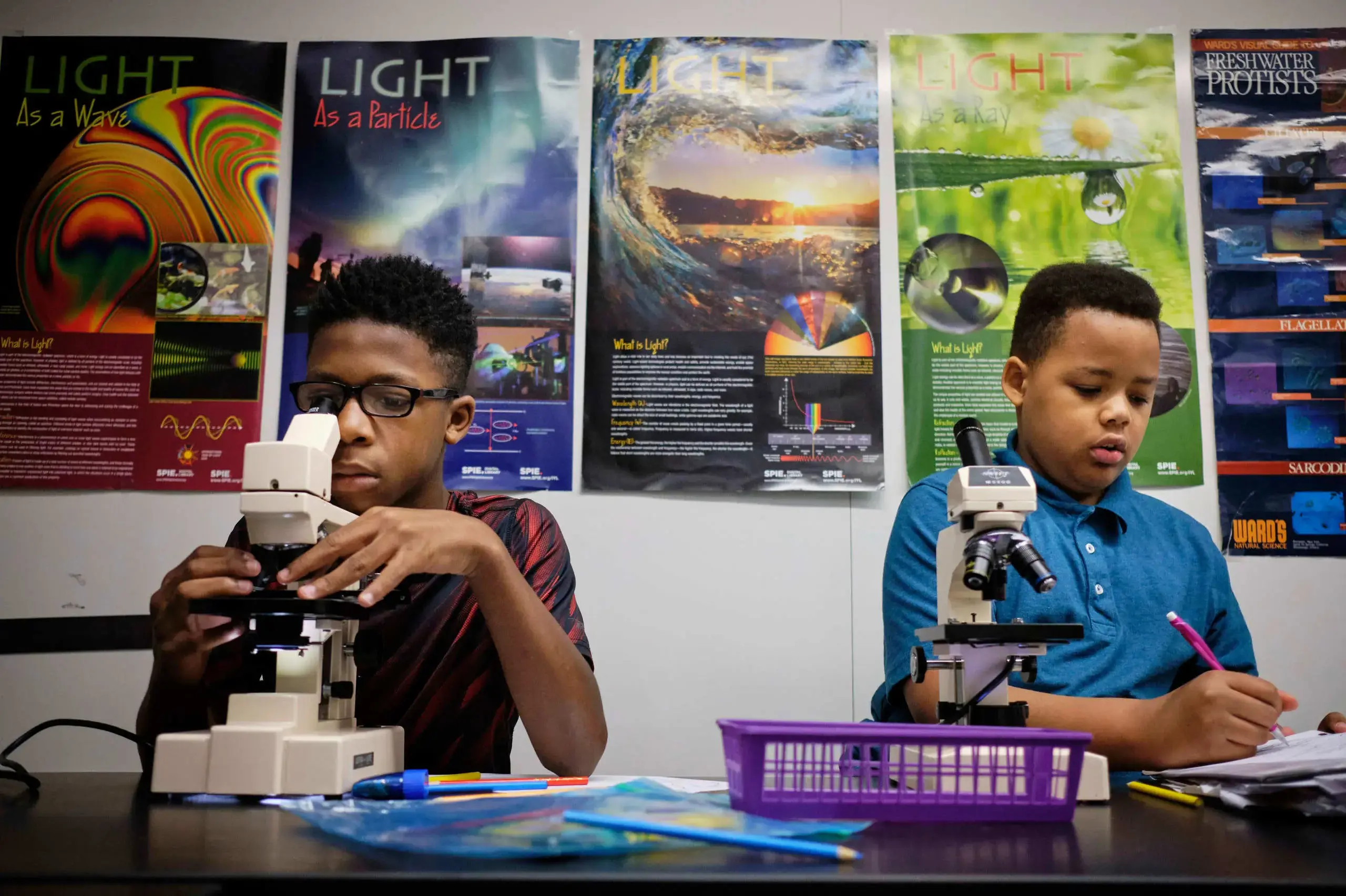 University School Students using microscopes in a science class.