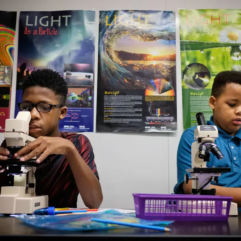 University School Students using microscopes in a science class.