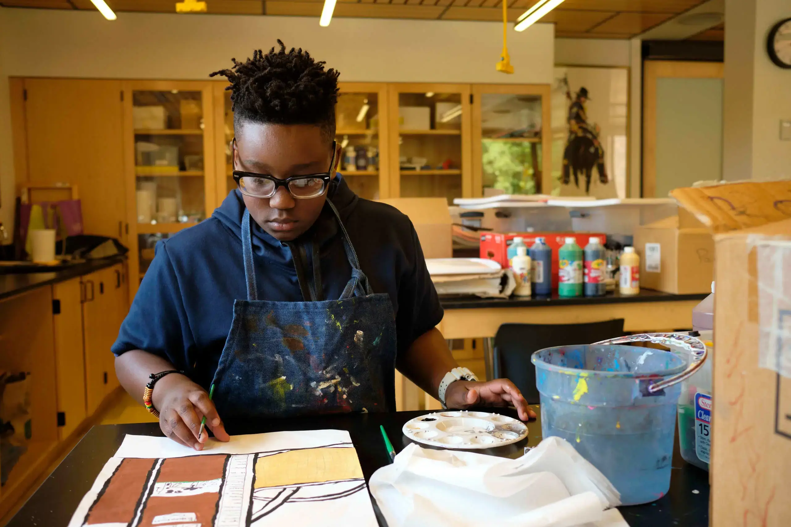 University School REACH Program student painting in an art class.