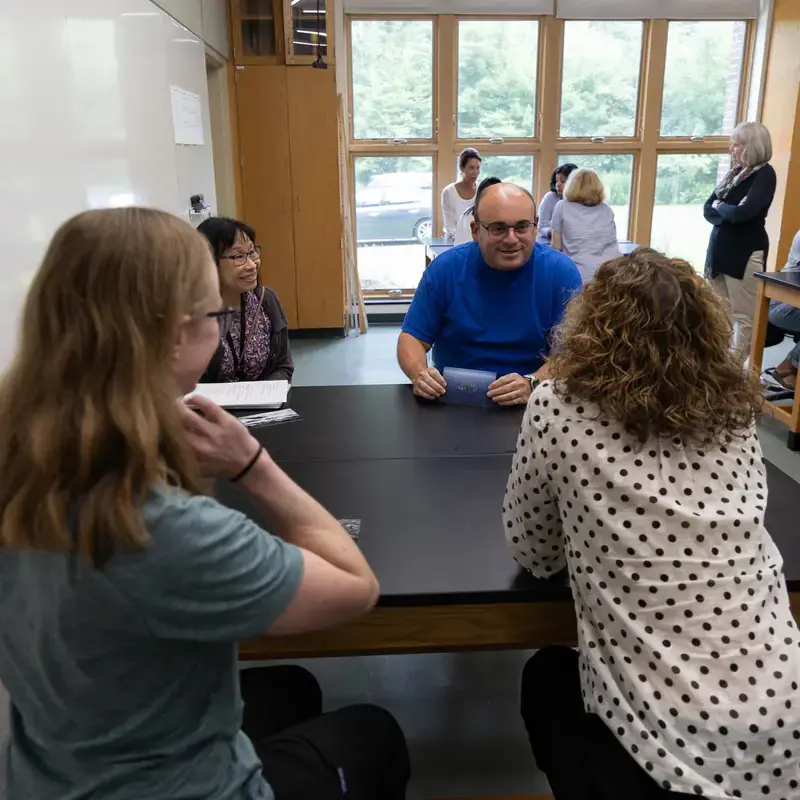 University School faculty sitting together, talking.