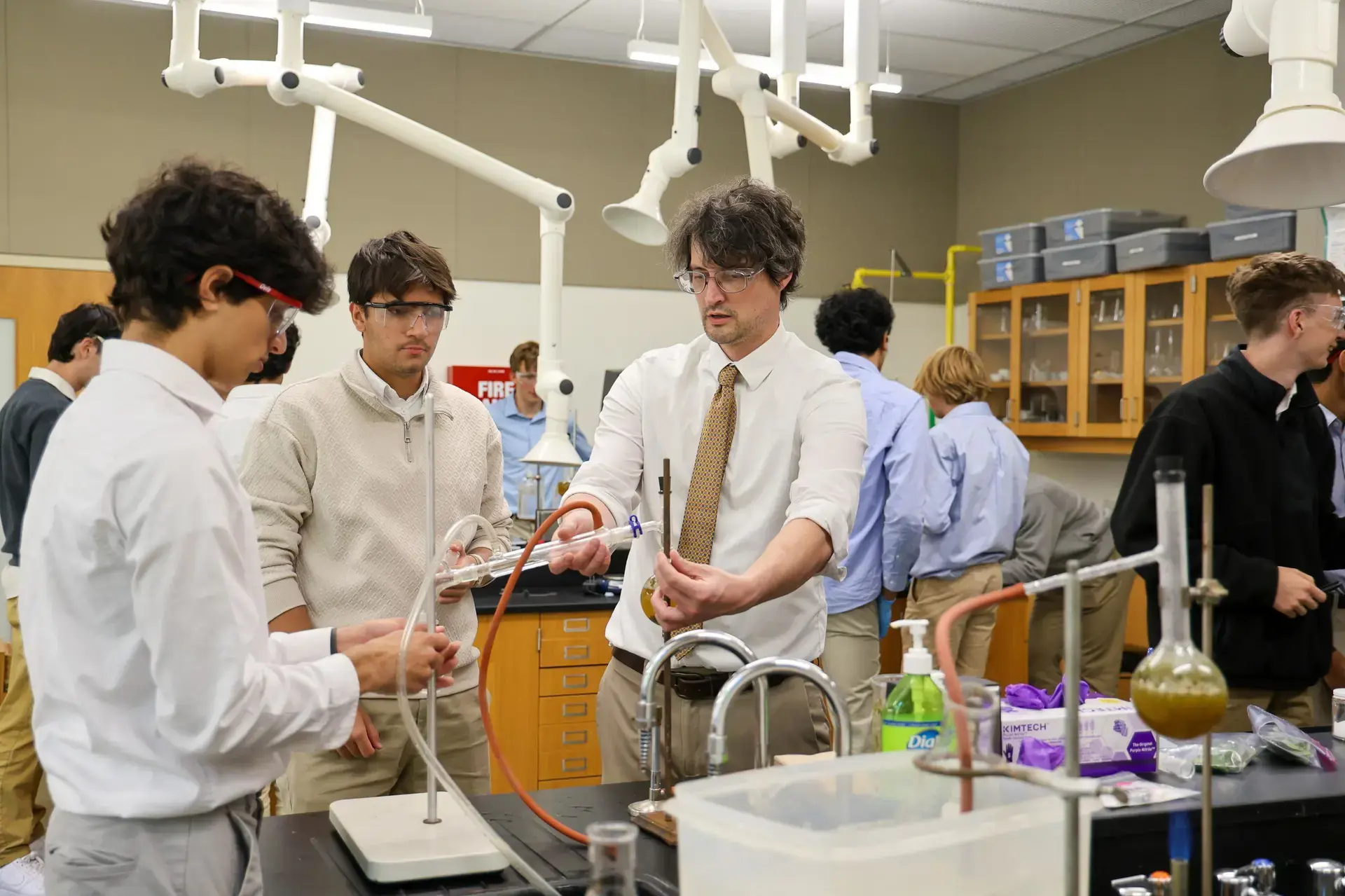 University School Senior students and teacher conducting an experiment in a science class.