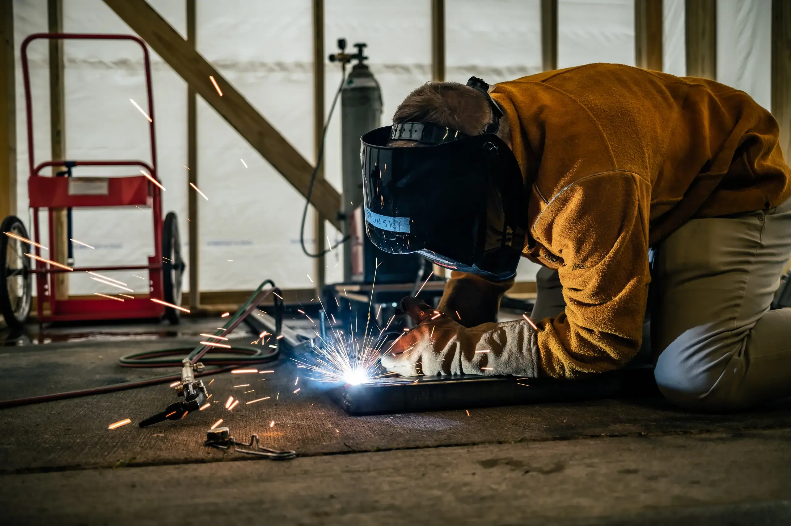 University School student welding as part of the Strnad Fellowship Program for their independent project.
