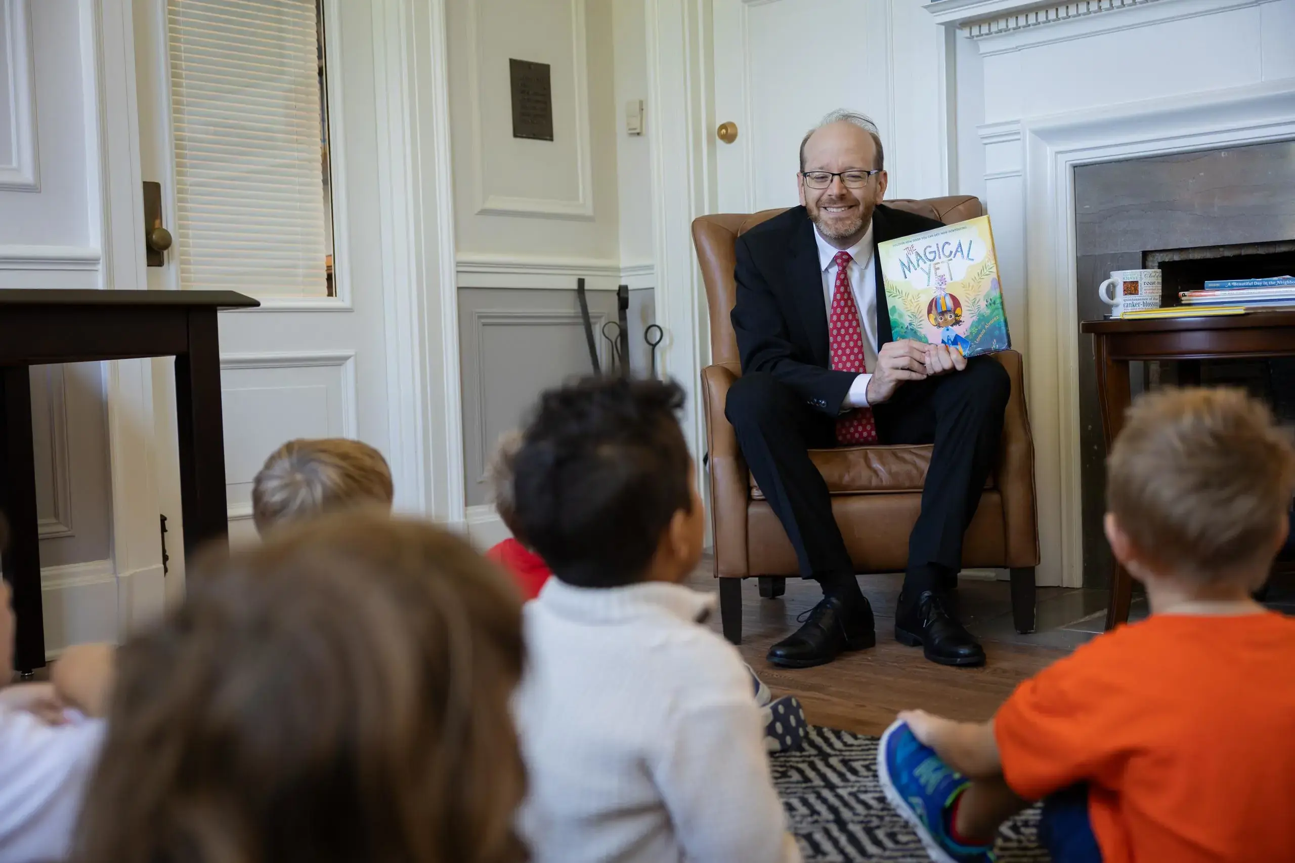 Patrick Gallagher reading a book to lower school junior-k class.