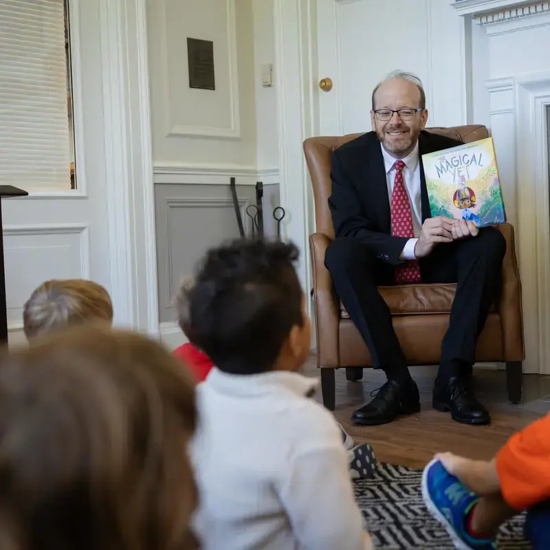 Patrick Gallagher reading a book to lower school junior-k class.