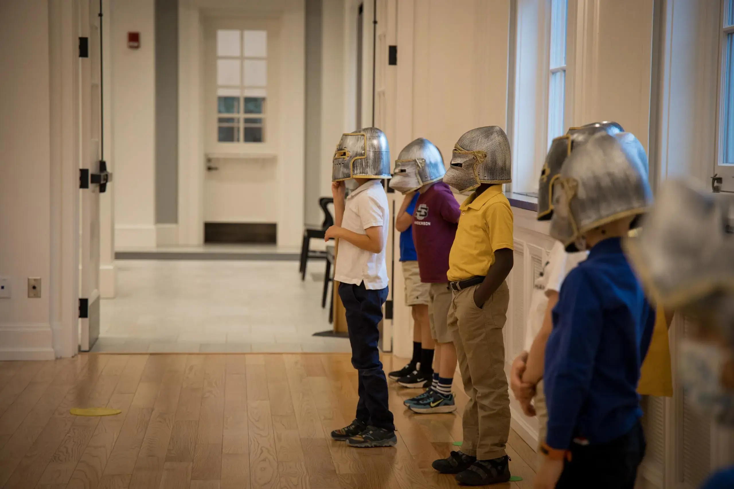 University School Kindergartners wearing medieval knight's helmets.