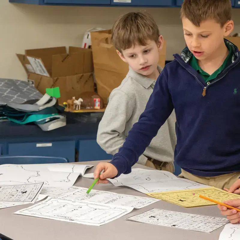 University School Third Grade students completing worksheets together in class.