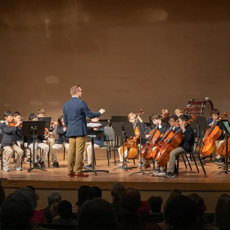 University School Middle School student orchestra performing at a concert.