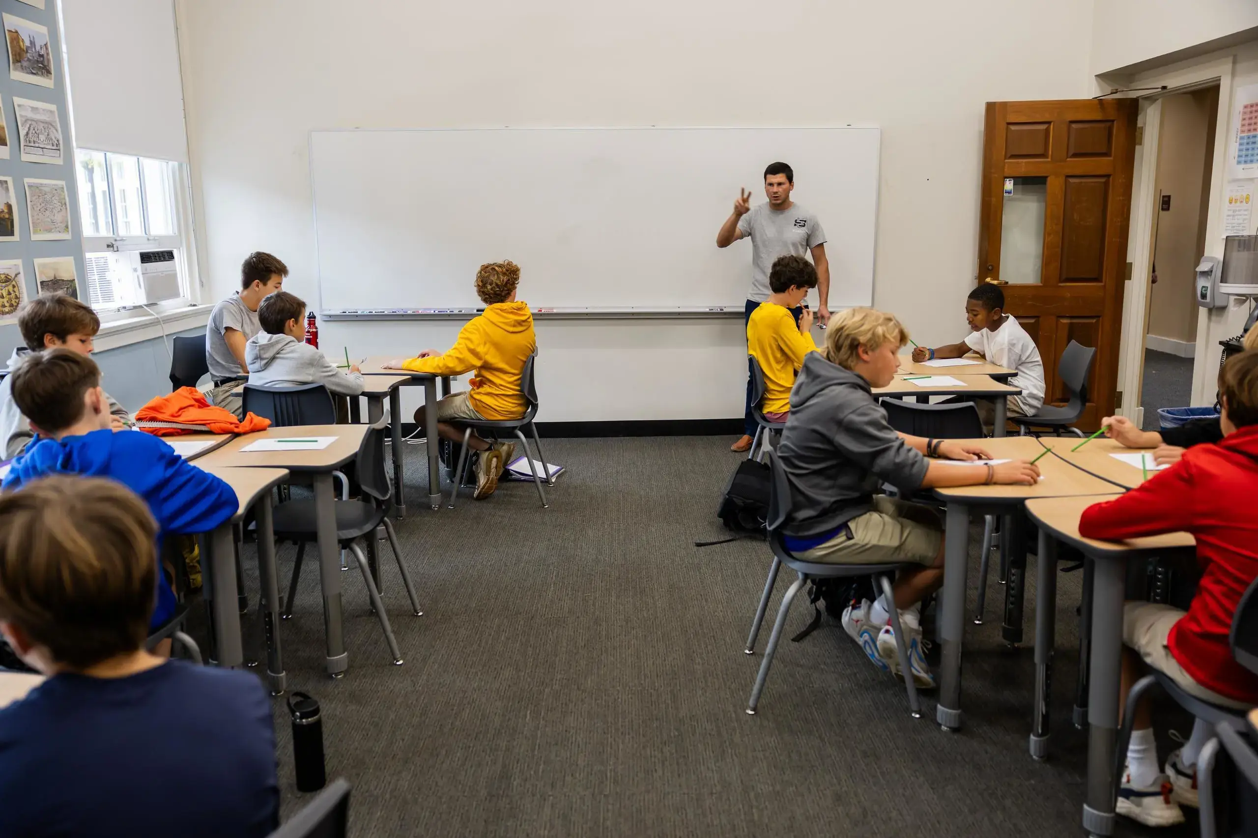 University School Middle School students listening attentively to a teacher in a Latin class.