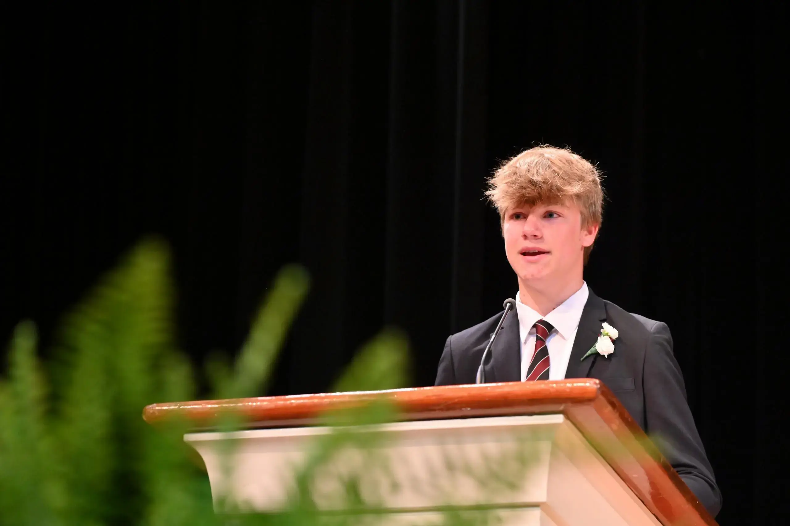 University School Middle School student speaking from a lectern.