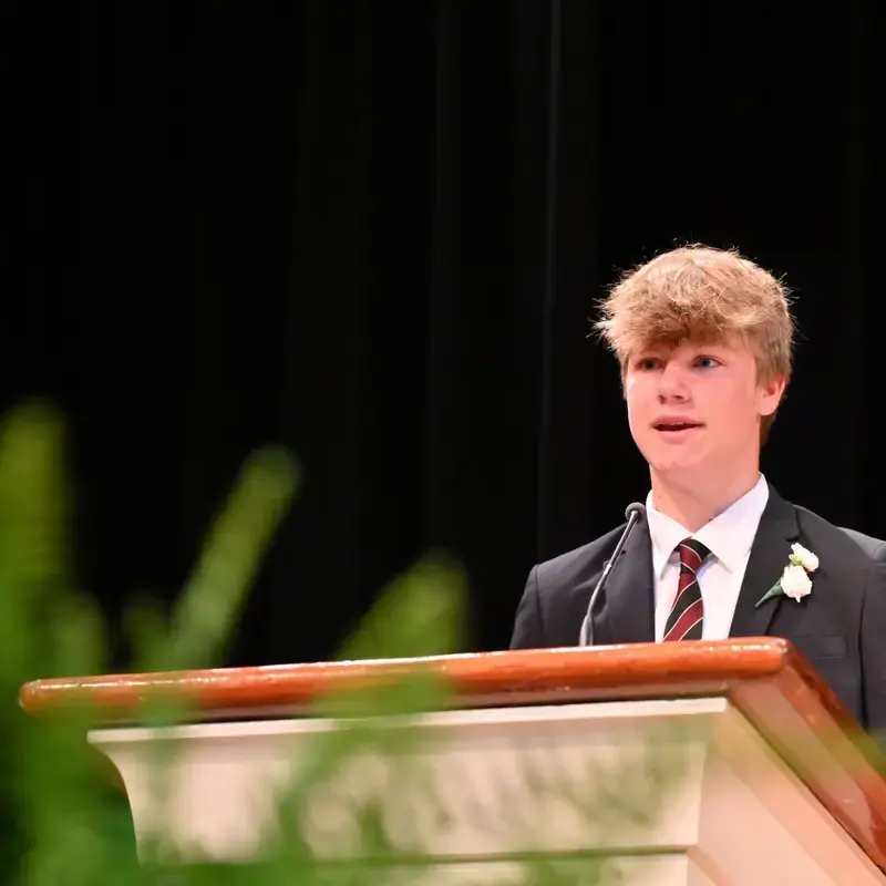 University School Middle School student speaking from a lectern.