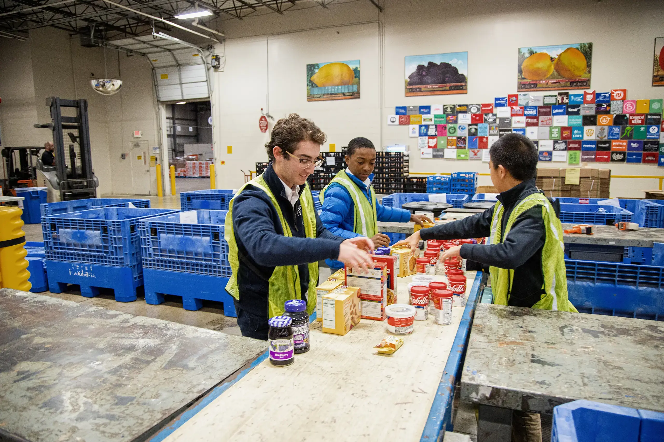 University School students wearing high vis vests sorting food donations as part of Community Engagement program.