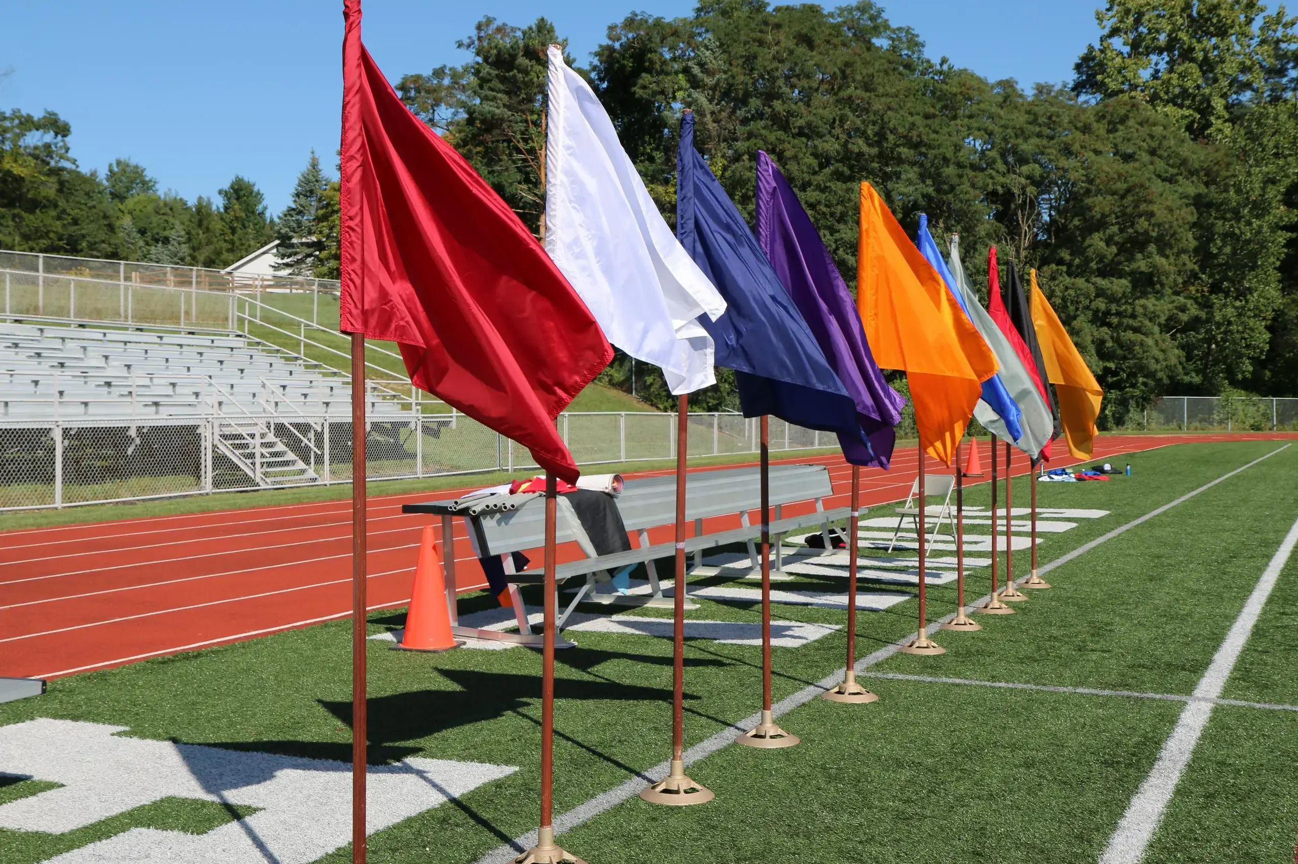 University School athletics fields with flags for each school house by the bleachers.