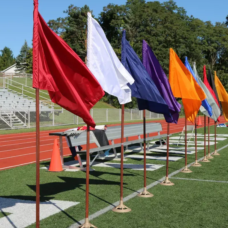 University School athletics fields with flags for each school house by the bleachers.