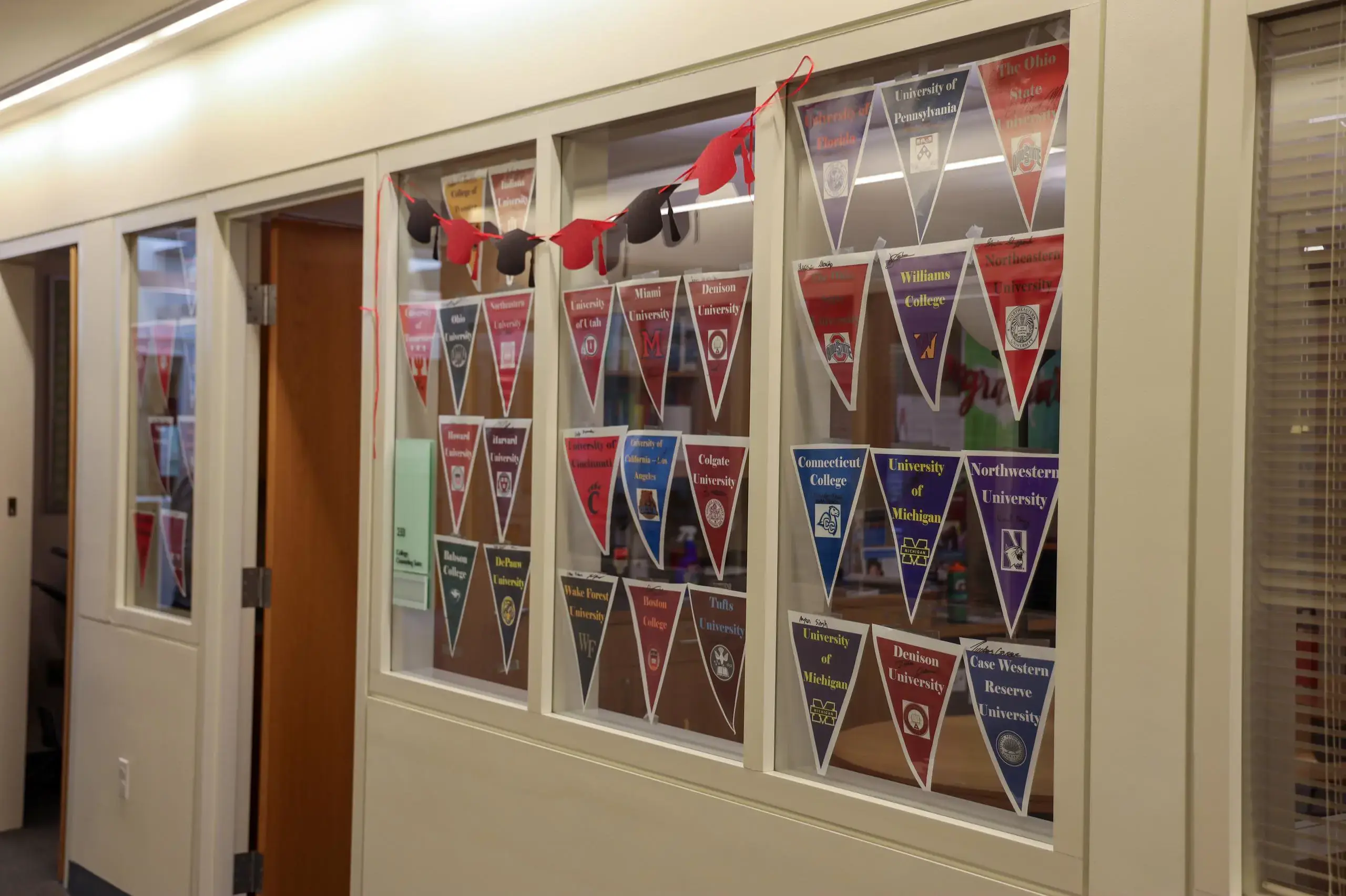 University School College Counseling department with college pennants and graduation cap bunting decorating the windows.