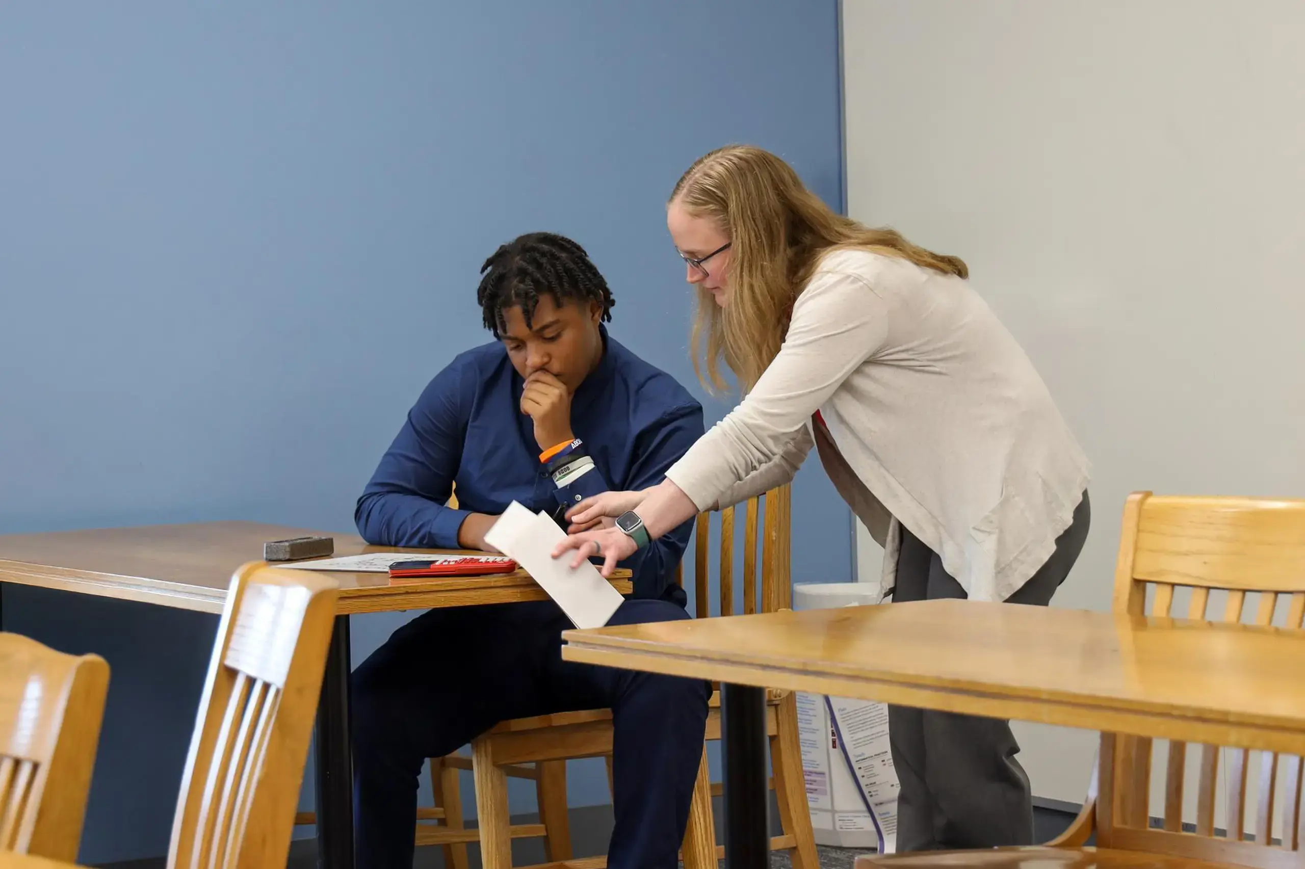 University School Upper School teacher discussing an equation with a student in a math class.