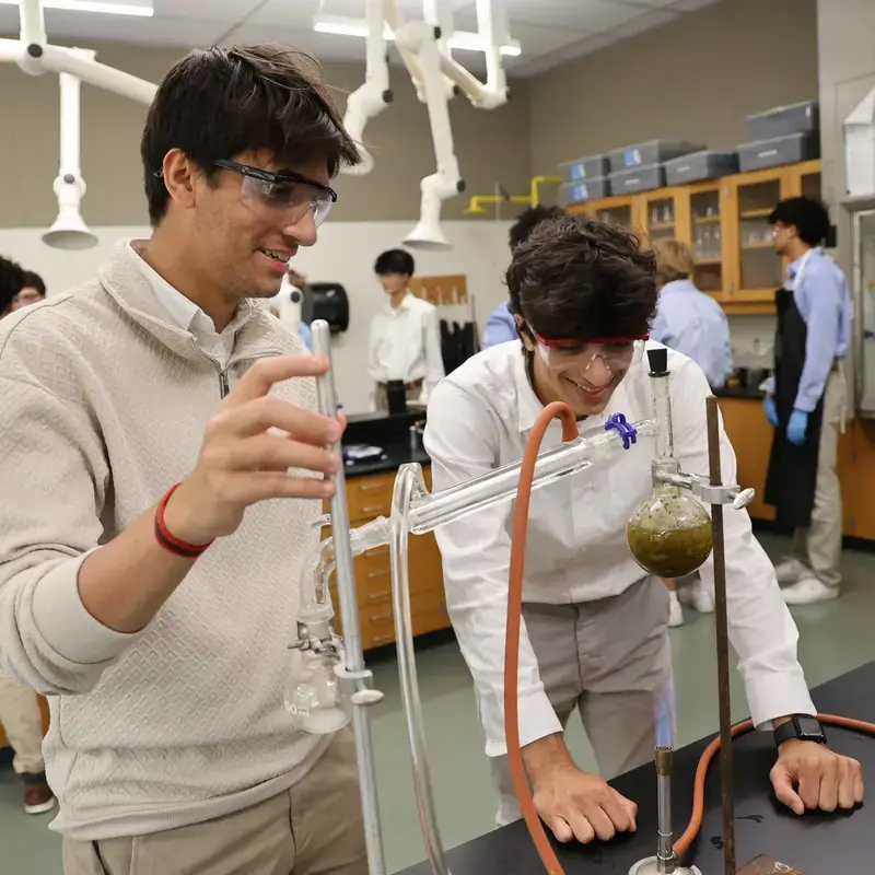 University School Upper School students conducting an experiment in a science class.